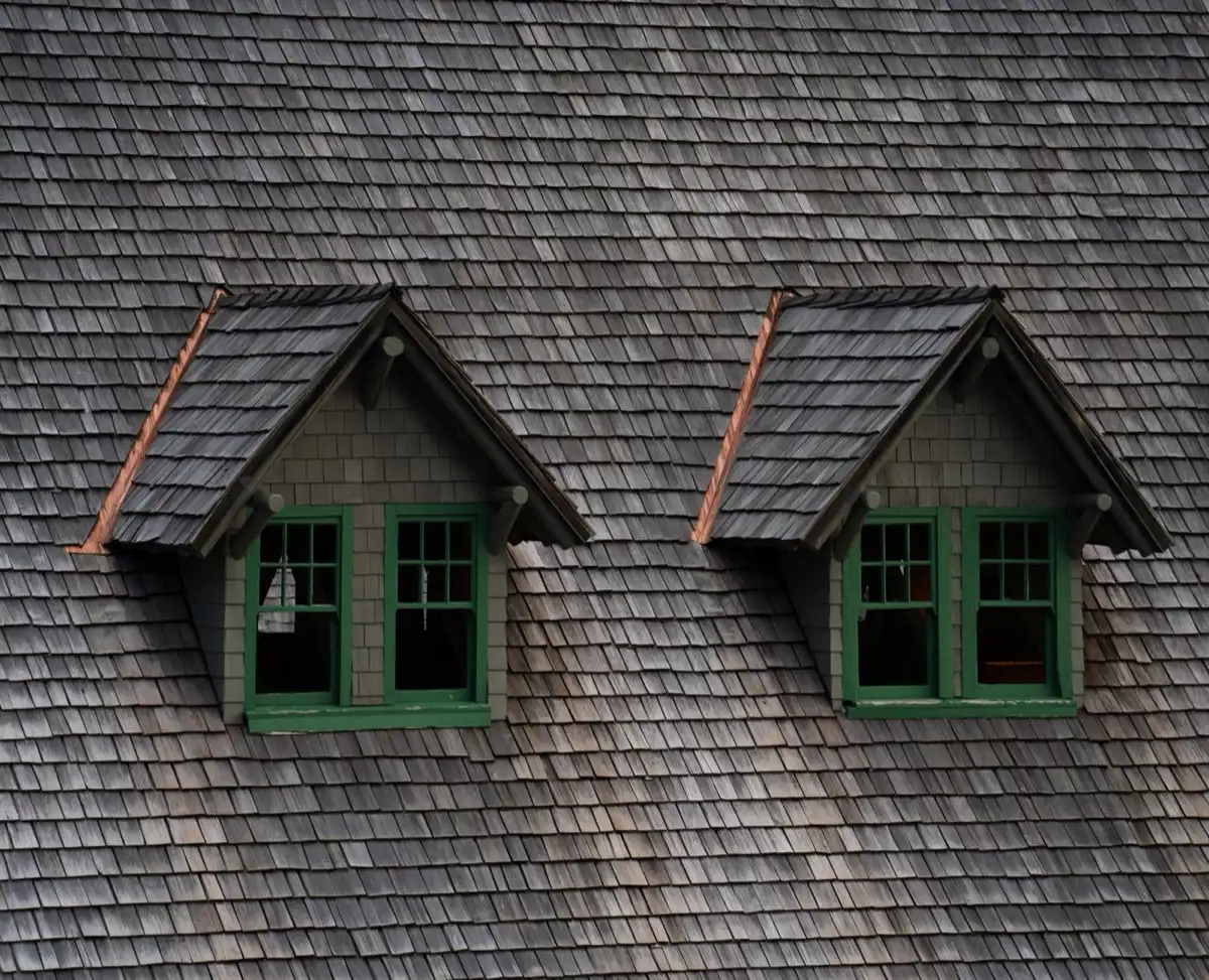 Dormers on a shingle roof in Bloomington, IL, where step flashing and kickout flashing carry water past the walls