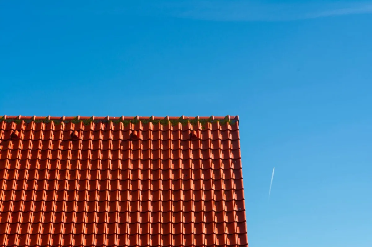 Tile roof gable in full sun, the kind of exposure that sets roof life in Bloomington, IL
